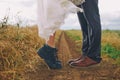 Male and female legs in boots in field. Love,kiss concept.