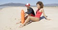 Male and female lifeguards sitting on beach