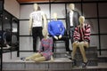 Male and female mannequins in western fashion displayed in a clothing store in a shopping mall.