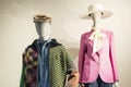 Male and female mannequins in fashionable bright clothes in the window of a clothing store. Front view Royalty Free Stock Photo