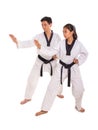 Male and female martial art practitioners perform strike move