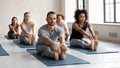 Multiracial people stretching muscles in seated forward bend pose. Royalty Free Stock Photo