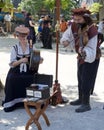 Male and female musicians in costumes perform on ancient instruments at a Renaissance Faire Royalty Free Stock Photo