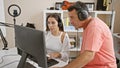 Male and female musicians vibing to their newly crafted melody in the music studio, deep in concentration yet relaxed Royalty Free Stock Photo