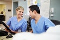 Male And Female Nurse Working At Nurses Station Royalty Free Stock Photo