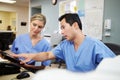 Male And Female Nurse Working At Nurses Station Royalty Free Stock Photo