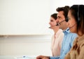 Male and female operators working with earphone Royalty Free Stock Photo