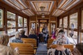 Male and female passengers travelling in vintage trams at city