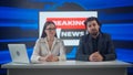 Male and female presenters in the studio. Man and woman news hosts sit at desk presenting daily events, reporting on air Royalty Free Stock Photo