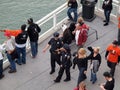 Male and female SFPD police officers walk down promenade along w