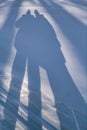 Male and female shadow on the snow in winter close-up