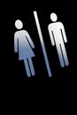 Male and female sign over black wall Royalty Free Stock Photo