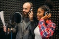 Male and female singers in audio recording studio Royalty Free Stock Photo