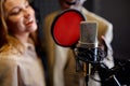 Male and female singers sings, recording studio