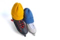 Male and female skates in knitted blue and yellow winter hats isolated on white background Royalty Free Stock Photo