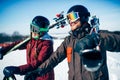 Male and female skiers poses with skis and poles