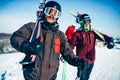 Male and female skiers poses with skis and poles