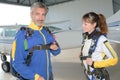 Male and female sky divers preparing their harnesses Royalty Free Stock Photo