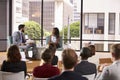 Male and female speakers in front of audience at a seminar Royalty Free Stock Photo