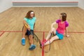 Male and female squash players taking break after the game