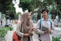 Male and female student holding tablet and books walking Royalty Free Stock Photo