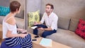 Male and female student studying together at library