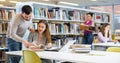 Male and female students preparing for exam together in library Royalty Free Stock Photo