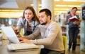 Male and female students preparing for exam together in library Royalty Free Stock Photo