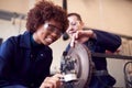 Male And Female Students Working On Car Brakes On Auto Mechanic Apprenticeship Course At College Royalty Free Stock Photo