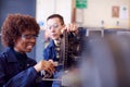 Male And Female Students Working On Car Brakes On Auto Mechanic Apprenticeship Course At College Royalty Free Stock Photo