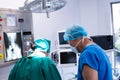 Male and female surgeon working in operation theater