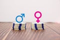Male and female symbols on piles of coins Royalty Free Stock Photo