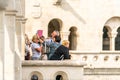 Male and female tourist standing at a viewpoint outside and below Matthias Church in Budapest. Royalty Free Stock Photo