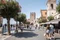 Male and female tourists exploring old townsquare during summer vacation