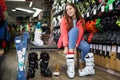 male and female are trying on boots for skiing