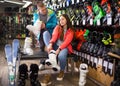 male and female are trying on boots for skiing