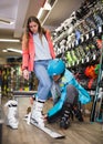 male and female are trying on boots for skiing