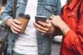 Male and female using smartphone outdoors Royalty Free Stock Photo