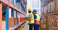 Male and female warehouse worker inspecting stock