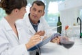 male and female wine specialists working in laboratory