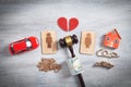 Male and female wooden symbols, gavel, house, car, money and judge gavel