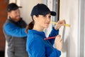 male and female worker measure wall Royalty Free Stock Photo