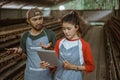 male and female worker worried looking at reports on tablet