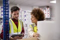 Male And Female Workers In Logistics Distribution Warehouse Using Digital Tablet Royalty Free Stock Photo