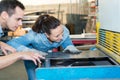 male and female workers in metalworks factory