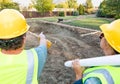 Pointing Male and Female Workers With Technical Blueprints Talking