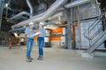 male and female workers talking in industrial manufacturing plant Royalty Free Stock Photo