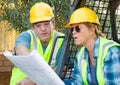 Male and Female Workers With Technical Blueprints Talking Royalty Free Stock Photo