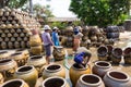 Male and female workers washing Dragon pattern flower pots.Focus at only male worker in front.