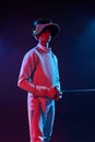 Male fencer standing on black background